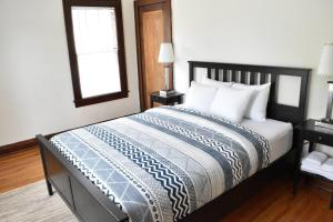 a bedroom with a large bed with white pillows and a window at The House Hotels - New Crestview in Columbus