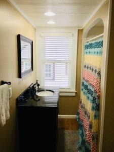 a bathroom with a sink and a window at The House Hotels - New Crestview in Columbus