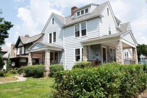 a white house with a gambrel roof at The House Hotels - New Crestview in Columbus