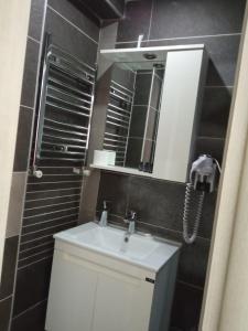 a bathroom with a sink and a mirror at Plaj resort dorra in Büyükçekmece