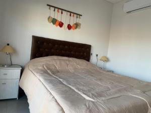 a bedroom with a large bed and two lamps at Experiencia Mendoza!! Bodegas y Montañas! in Godoy Cruz