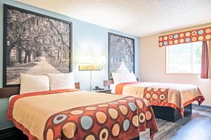 Ένα ή περισσότερα κρεβάτια σε δωμάτιο στο Super 8 by Wyndham Augusta Ft Eisenhower Area