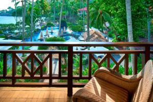 a balcony with a view of a resort with a pool at Sheraton Senggigi Beach Resort in Senggigi