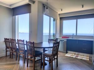a kitchen and dining room with a table and chairs at Holiday`s House "Four Generations" in Seixal