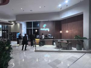 a lobby of a hotel with people standing in the lobby at Holiday Inn Bogota Airport, an IHG Hotel in Bogotá