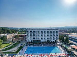 a large white building with a large swimming pool at Bella Vista in Jagodina