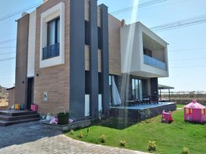 a large house with a grassy yard in front of it at Villa in Antalya