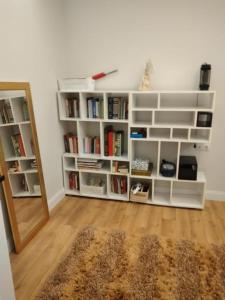 a room with white book shelves and a mirror at Villa in Antalya