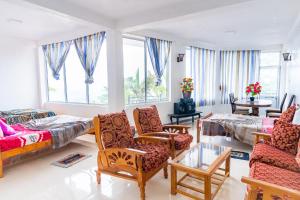 a living room with a couch and chairs at Adisham village home in Haputale