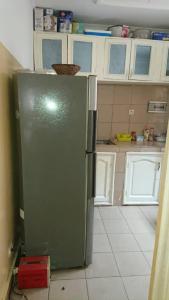 a kitchen with a green refrigerator in a room at AUBERGE-NGOMSON in Brazzaville