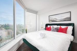 a bedroom with a large bed and large windows at Luxury Apartment in Yorkville Downtown Toronto with City View in Toronto