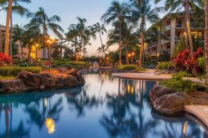 a swimming pool with palm trees and a resort at Koloa Landing Resort at Po'ipu, Autograph Collection in Koloa