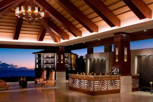 a lobby with a bar with a view of the ocean at Koloa Landing Resort at Po'ipu, Autograph Collection in Koloa