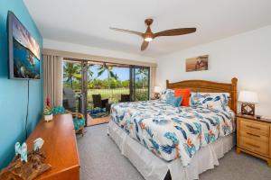 a bedroom with a bed and a large window at Big Island Keauhou Punahele E202 condo in Kailua-Kona