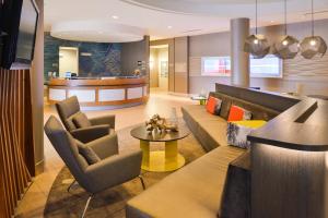 a lobby with a couch and two chairs and a table at SpringHill Suites by Marriott Corona Riverside in Corona