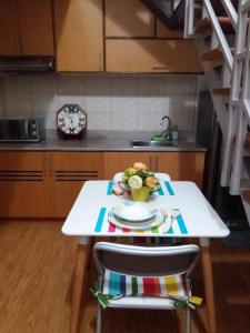 uma cozinha com uma mesa branca com uma tigela de comida em Beautiful condo with WIFI and pool near Nuvali em Cavite