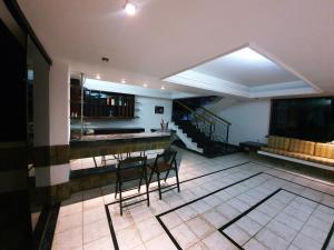 a kitchen with a table and chairs in a room at Casa Mais in Aracaju