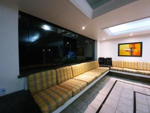 a couch in a room with a large window at Casa Mais in Aracaju