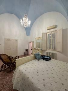 a bedroom with a large bed and a chandelier at Casa Vacanze Gallipoli in Gallipoli