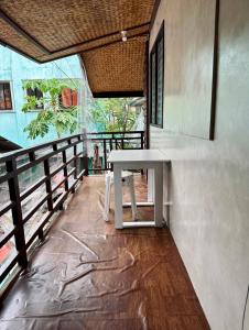 a white table sitting on the side of a building at El Nido U Inn in El Nido