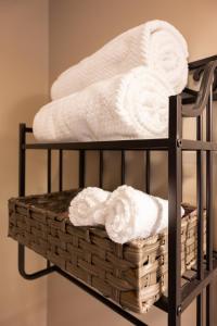 a towel rack with towels and a basket on it at Luxury Federal Hill Home with Rooftop & 4 Parking Spots in Baltimore