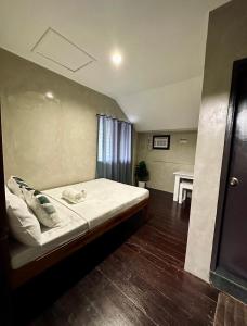a bedroom with a bed and a table in it at El Nido U Inn in El Nido
