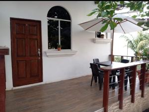 a dining room with a table and chairs and a door at Konchamar in La Libertad +36 photos