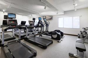 a gym with several treadmills and exercise bikes at SpringHill Suites Tempe at Arizona Mills Mall in Tempe