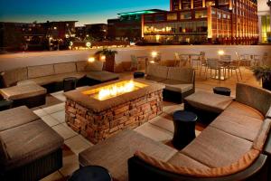 a rooftop patio with a fireplace and tables and chairs at SpringHill Suites by Marriott Pittsburgh Bakery Square in Pittsburgh