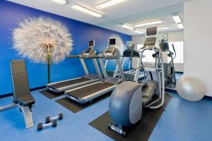 a gym with treadmills and machines in a room at SpringHill Suites Phoenix North in Phoenix