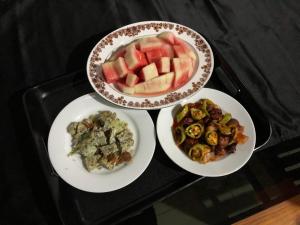 trois assiettes de nourriture sur un plateau noir dans l'établissement Haritha Holidays, à Minneriya