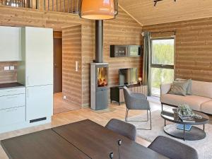 a living room with a couch a table and a fireplace at 6 person holiday home in Sollia-By Traum in Brenn