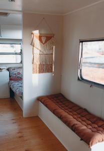 a bench in the corner of a room with a window at Meralda Station in Cobar