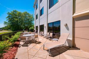 a patio with chairs and tables next to a building at SpringHill Suites Mishawaka-University Area in South Bend