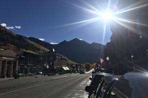 a sun is shining on a street in a town at Northstar 18 in Telluride