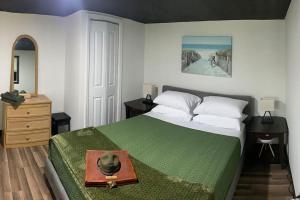 a bedroom with a bed with a plate on it at Field Quarters in Pensacola