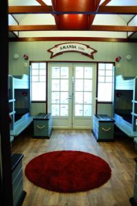 a room with bunk beds and a red rug at Villa Elba in Kokkola
