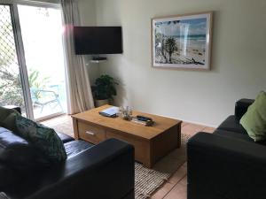 a living room with a couch and a coffee table at Mudjimba Esplanade Villa in Mudjimba