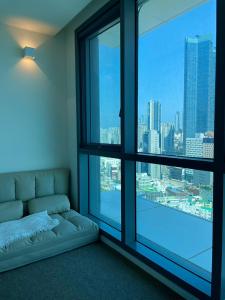 a living room with a couch and a large window at ElbonThe Beach Haeundae in Busan