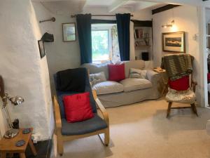 a living room with two chairs and a couch at Court House in Solva