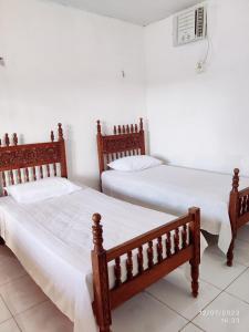 Un pat sau paturi într-o cameră la Pousada Três Marias