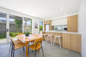 a kitchen and dining room with a table and chairs at Denham Court Adorable 4Br house with Wifi &Parking in Horningsea Park