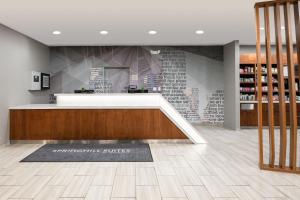 a store lobby with a counter and a rug on the floor at SpringHill Suites by Marriott Tulsa in Union
