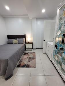 a bedroom with a bed and a dresser and a mirror at Chalet Belizomi Tropical Villa #1 in Gros Islet