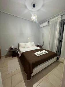 a bedroom with a bed with two towels on it at Lefkas Apartment in Lefkada Town