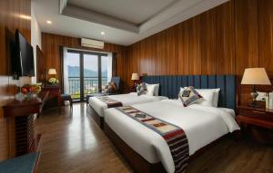 Postel nebo postele na pokoji v ubytování Bamboo Sapa Hotel