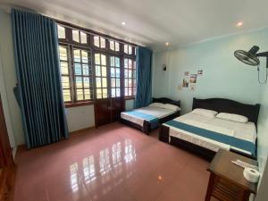 1 dormitorio con 2 camas y ventana en Cat Ba Life Hostel en Hai Phong