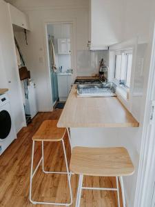 a kitchen with a wooden counter top in a room at Little Lodge - Luxury Tiny Home Stay in Alstonville