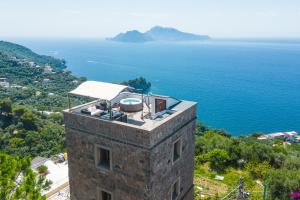 um edifício com uma piscina em cima junto ao oceano em Torre Valentino em Massa Lubrense