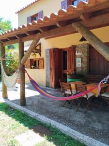 a hammock in front of a house at Quinta Meneses in Santa Cruz